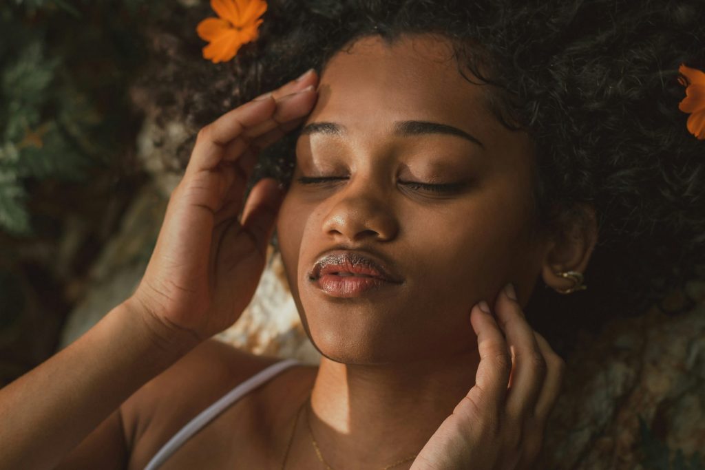 How Stress Affects Your Skin & How to Fix It: Expert Skincare Tips That Work Photo - A woman resting and smiling