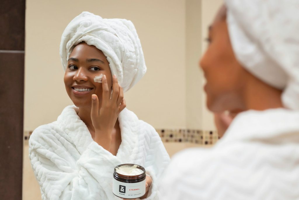 Strengthen & Glow: The Power of Skin Barrier Repair Treatments at Crystalline Clinic Photo - A woman putting a cream on her face which is a Skin Barrier Repair Treatments