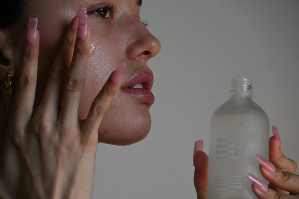 Strengthen & Glow: The Power of Skin Barrier Repair Treatments at Crystalline Clinic Photo - A woman putting a lotion on her face