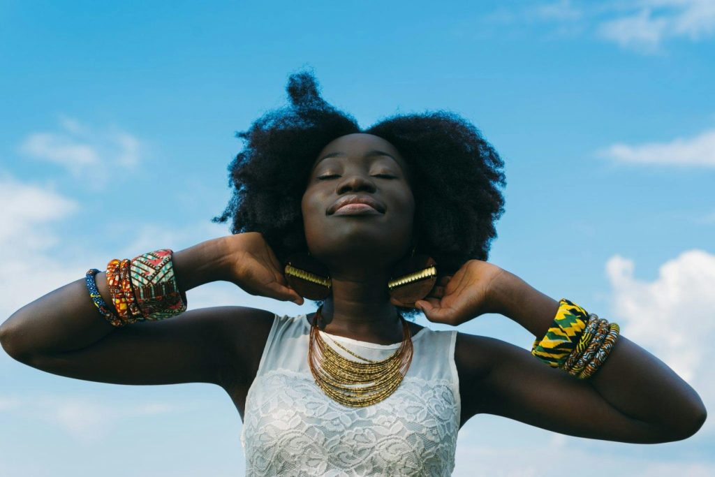 Unlock Radiance and Vitality with Vitamin Booster Injections Photo - A woman standing outside happy after vitamin booster injections