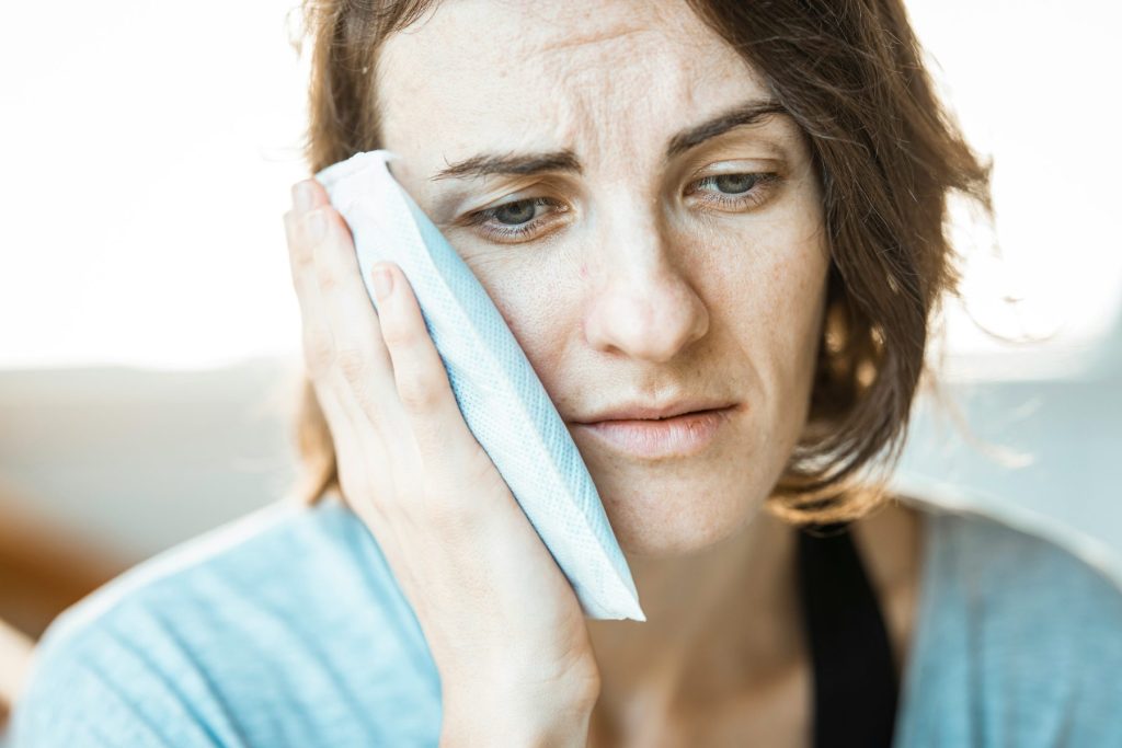Botox for Teeth Grinding: A Gentle, Effective Solution at Crystalline Clinic Photo - A woman who's jaw hurts and is going to get  Botox for teeth grinding.